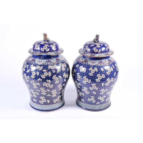 165 - A pair of large Chinese porcelain vases and covers, Qing, 18th century, later decorated in Canton pr... 