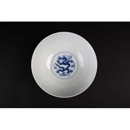 178 - A Chinese blue 7 white dragon bowl, Republic period, painted with two Imperial dragons amongst ruyi ... 