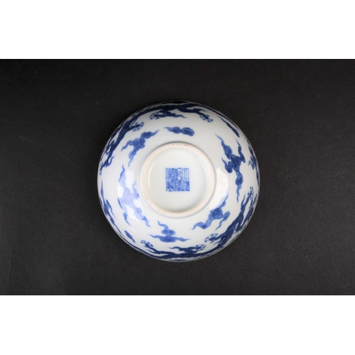 178 - A Chinese blue 7 white dragon bowl, Republic period, painted with two Imperial dragons amongst ruyi ... 