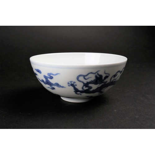 178 - A Chinese blue 7 white dragon bowl, Republic period, painted with two Imperial dragons amongst ruyi ... 