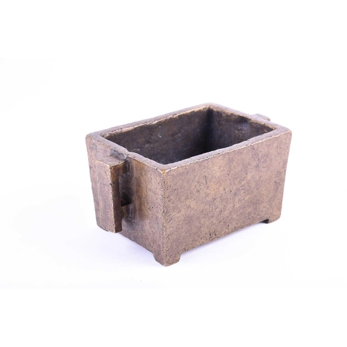 181 - A Chinese bronze censor, of rectangular form, with two conforming handles, on short bracket feet, si... 