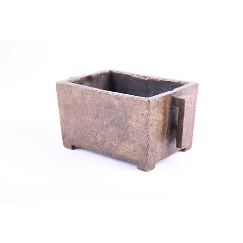 181 - A Chinese bronze censor, of rectangular form, with two conforming handles, on short bracket feet, si... 