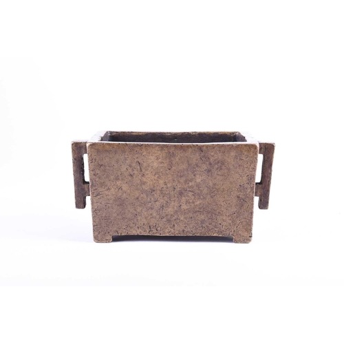 181 - A Chinese bronze censor, of rectangular form, with two conforming handles, on short bracket feet, si... 