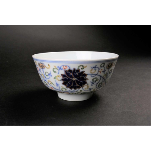 182 - A Chinese doucai Lotus bowl, painted with blue lotus flowers amongst fronds above a false gadroon bo... 