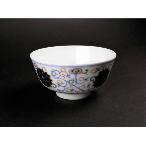 182 - A Chinese doucai Lotus bowl, painted with blue lotus flowers amongst fronds above a false gadroon bo... 