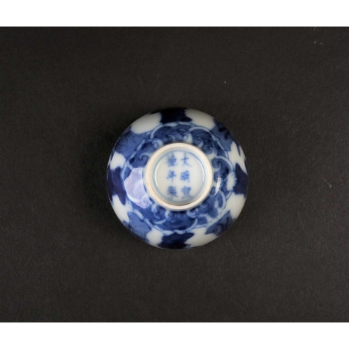 189 - A Chinese blue & white wine cup, Qing, painted with eight immortals above a band of waves, apocrypha... 