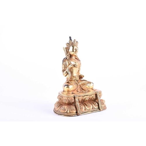 192 - A Sino Tibetan gilt bronze figure of Manjushri, decorated with cast jewels and robes, seated on a do... 