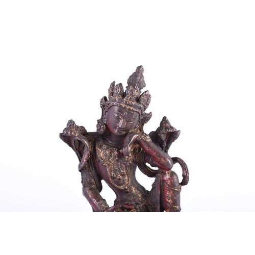 197 - A Sino Tibetan bronze figure of Boddhisatva tara, on double lotus petal throne, traces of red pigmen... 