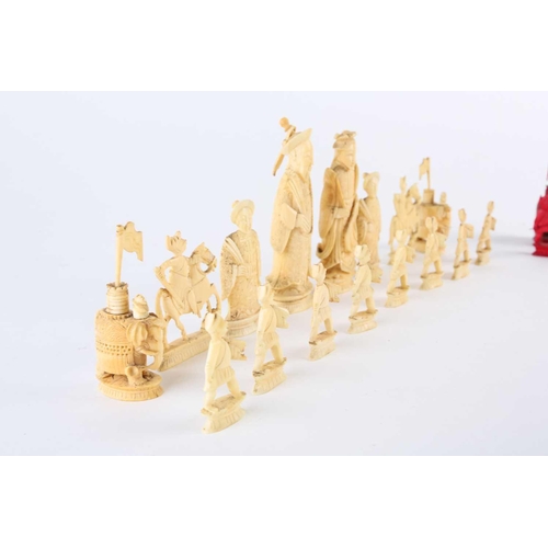 202 - A Chinese natural and red stained ivory chess set, late 19th/early 20th century, the red king 11cm, ... 