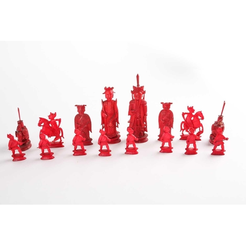 202 - A Chinese natural and red stained ivory chess set, late 19th/early 20th century, the red king 11cm, ... 