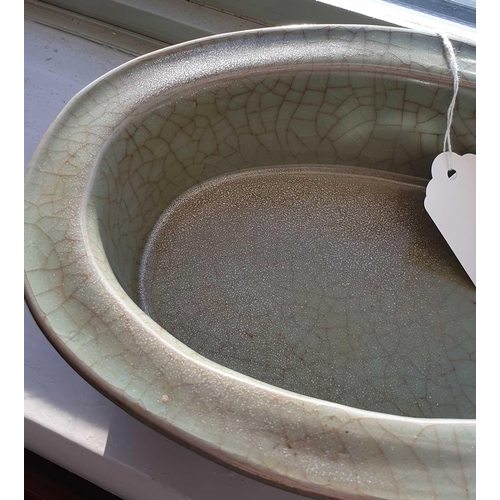 203 - A Chinese celadon jardiniere, 中国，青瓷花盆一件，20世纪 20th century, the flat rim and deep well with a grey/gr... 