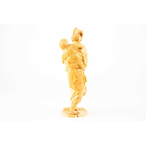 209 - A Japanese ivory okimono, Meiji period, carved as a mother and child, a basket in her right hand, si... 