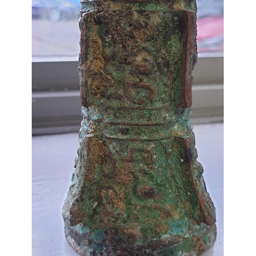 224 - A Chinese cast bronze Gu form ritual wine vessel, Shang Dynasty, with flaring rim above the tapering... 