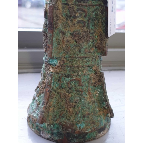 224 - A Chinese cast bronze Gu form ritual wine vessel, Shang Dynasty, with flaring rim above the tapering... 