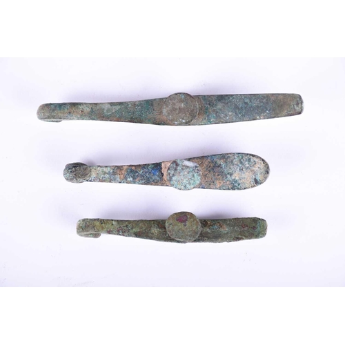 226 - Three Chinese bronze belt hooks, Warring States or later, each of typical elongated form, one with a... 