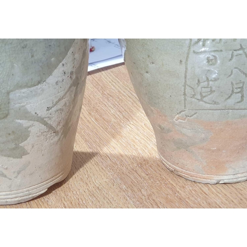 232 - Two Chinese celadon funerary vases, one dated 1404, each with elongated ovoid body, engraved with a ... 