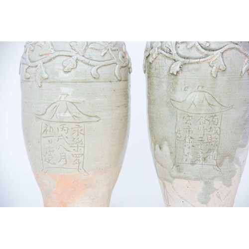 232 - Two Chinese celadon funerary vases, one dated 1404, each with elongated ovoid body, engraved with a ... 