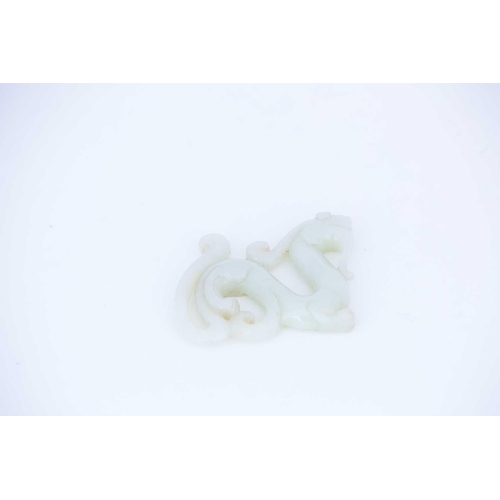 247 - A Chinese carved jade archaic dragon, the stone a uniform colour throughout, 7cm long, 5.5cm high