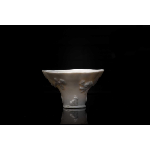 248 - A Chinese blanc de Chine cup, 18th/19th century, modelled as a Rhinoceros horn libation cup, with re... 