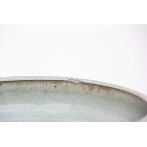 249 - A Chinese celadon bowl, 14th/15th century, 中国，青瓷大碗一件，14/15世纪 with incurved rim above a body engraved... 