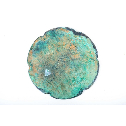 254 - A Chinese bronze mirror, Tang, 中国，铜镜一个，唐代 the six lobes enclosing relief tendrils and with three cha... 