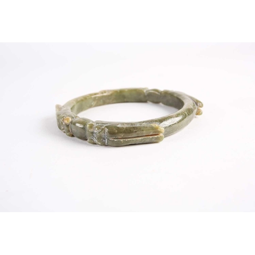 273 - A Chinese spinach green jade bangle, Warring States period, with four opposing dragons with long ear... 