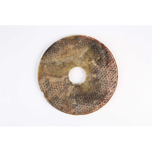 274 - A large Chinese jade Bi disc, Western Han dynasty, the stone a mix of green and brown, of typical fo... 