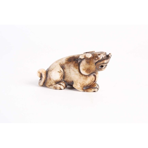 284 - A Chinese jade lion dog, Qing dynasty, late 19th century, modelled prowling with raised head, the st... 