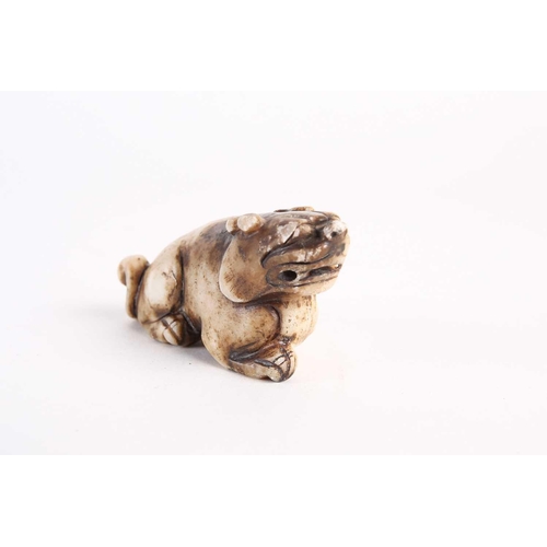 284 - A Chinese jade lion dog, Qing dynasty, late 19th century, modelled prowling with raised head, the st... 