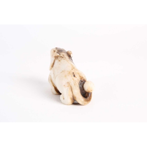 284 - A Chinese jade lion dog, Qing dynasty, late 19th century, modelled prowling with raised head, the st... 