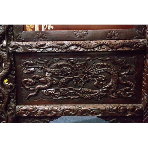 311 - A Japanese carved blackwood and ivory screen, Meiji period, circa 1880, the panels applied with high... 