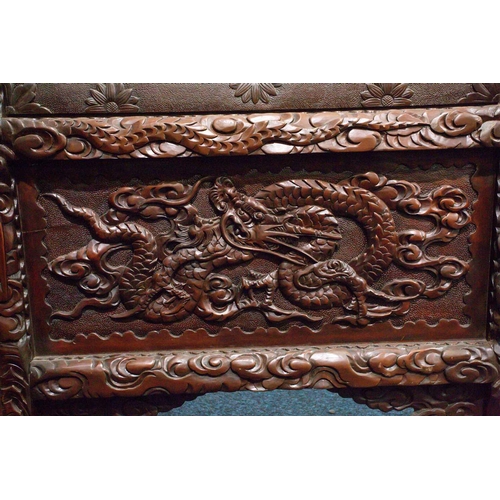 311 - A Japanese carved blackwood and ivory screen, Meiji period, circa 1880, the panels applied with high... 