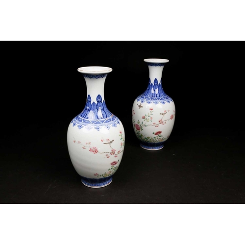 317 - A pair of Chinese Famille rose vases, the neck painted with a band of ruyi heads above a shoulder of... 