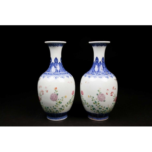 317 - A pair of Chinese Famille rose vases, the neck painted with a band of ruyi heads above a shoulder of... 