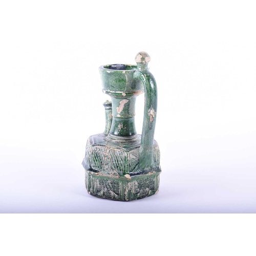 322 - An Islamic green glazed earthenware ewer, possibly Ommayad, the neck with generous mouth above the h... 