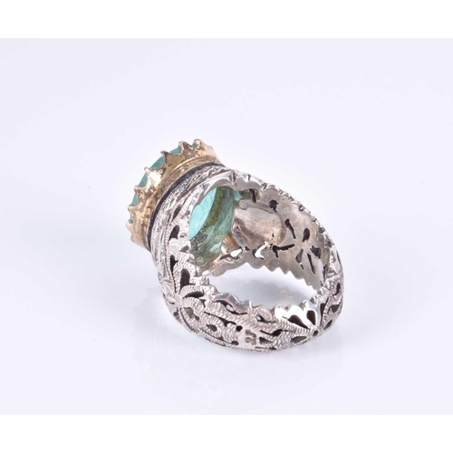 342 - An unusual silver and emerald Islamic ring, set with a mixed oval-cut emerald engraved with Islamic ... 