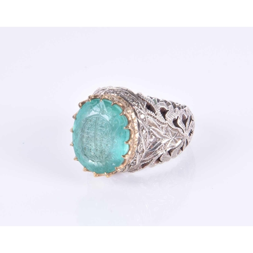 342 - An unusual silver and emerald Islamic ring, set with a mixed oval-cut emerald engraved with Islamic ... 