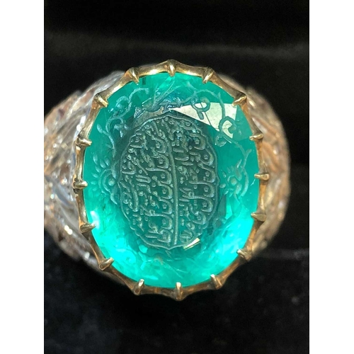 342 - An unusual silver and emerald Islamic ring, set with a mixed oval-cut emerald engraved with Islamic ... 