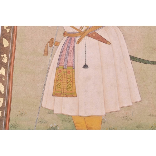 358 - Indian School, 20th century, a full length portrait of a nobleman, with talwar and katar, resting ag... 