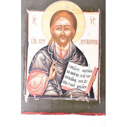 378 - A late 19th century Russian icon, canvas on wood, Christ Pantocrator, with cyrillic text within a da... 