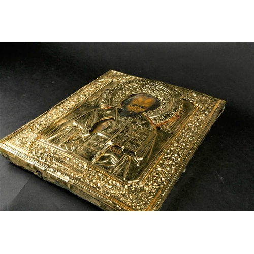 380 - A 19th century painted Russian icon on wood, with later overlaid gilt metal plaque, relief decorated... 