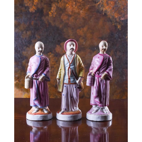 388 - A group of three 19th century porcelain figures, 'People from the East', painted in polychrome ename... 