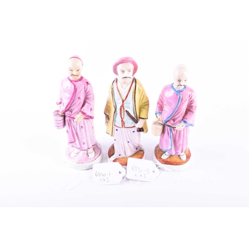 388 - A group of three 19th century porcelain figures, 'People from the East', painted in polychrome ename... 