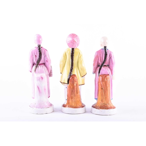 388 - A group of three 19th century porcelain figures, 'People from the East', painted in polychrome ename... 