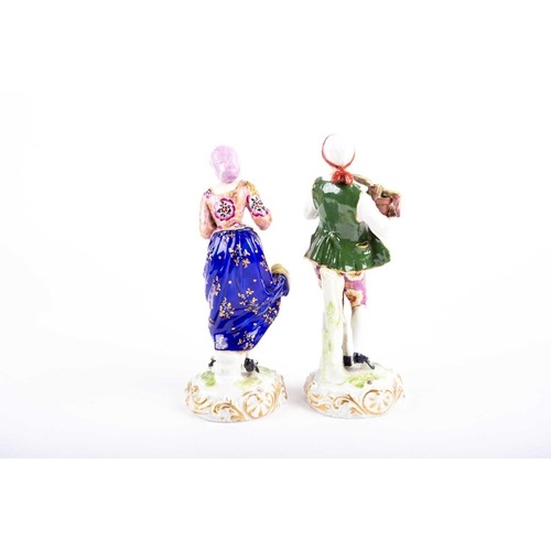 397 - A pair of late 18th century Derby porcelain figurines, he carrying a plant and she with apples, dres... 