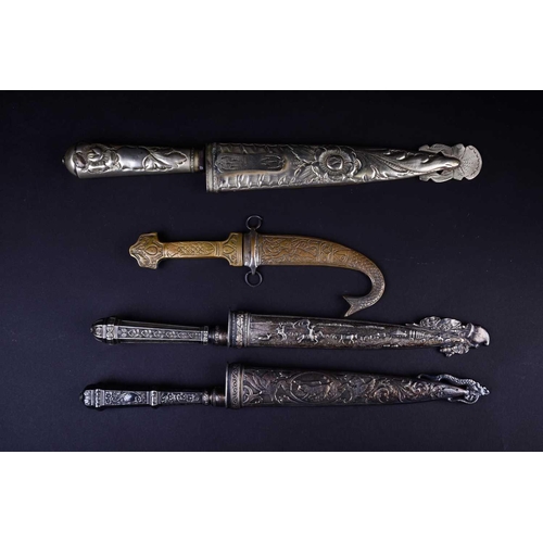 419 - Three Gaucho knives, two with white metal embossed handles and scabbards, one of which marked for Ab... 