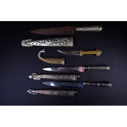 419 - Three Gaucho knives, two with white metal embossed handles and scabbards, one of which marked for Ab... 