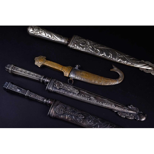 419 - Three Gaucho knives, two with white metal embossed handles and scabbards, one of which marked for Ab... 