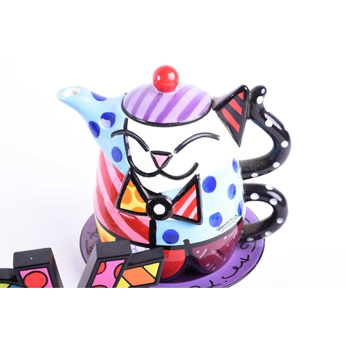 468 - Romero Britto (b.1963) Brazilian, a ceramic stacking teapot on stand, typically painted in abstract ... 