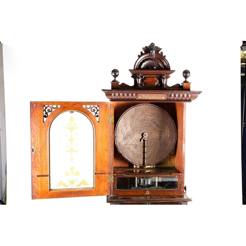 489 - An impressive Victorian mahogany 'Penny in the Slot' Polyphon on associated stand, the arched glazed... 